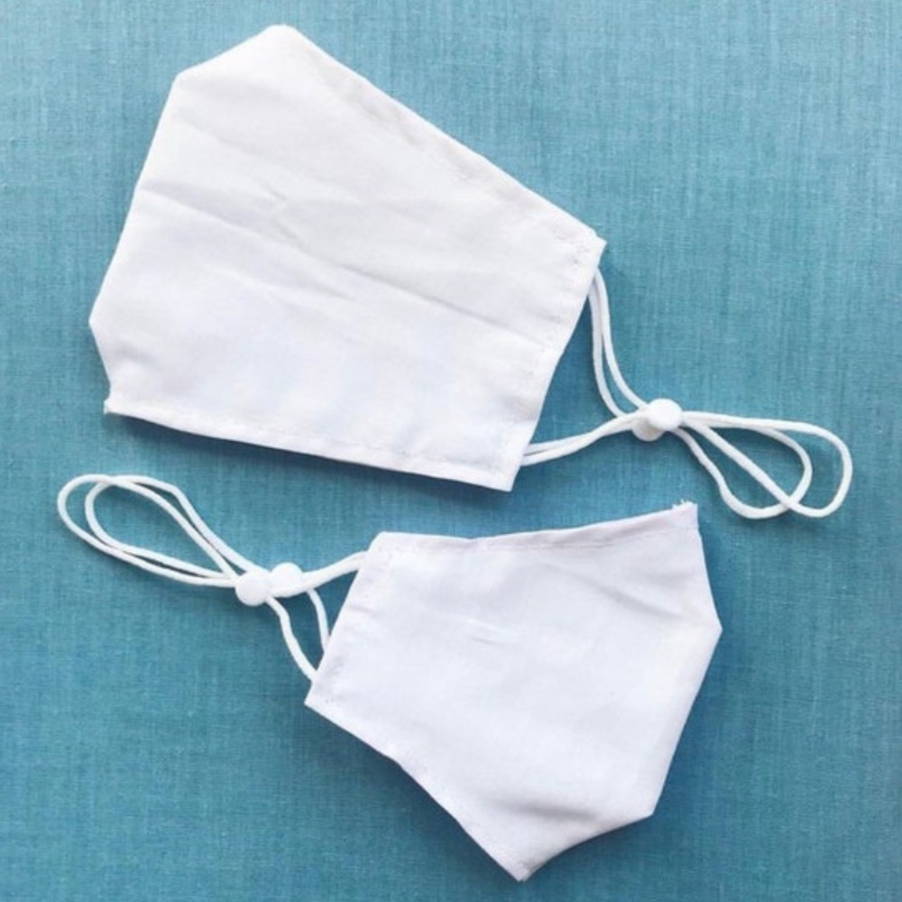 Face mask in white with adjustable straps in adult and child sizes